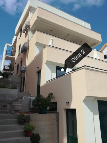 a building with a sign on the side of it at Olea in Tivat