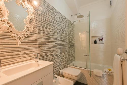 a bathroom with a tub and a toilet and a sink at MyPlaceLisbon - Tágides River View in Lisbon