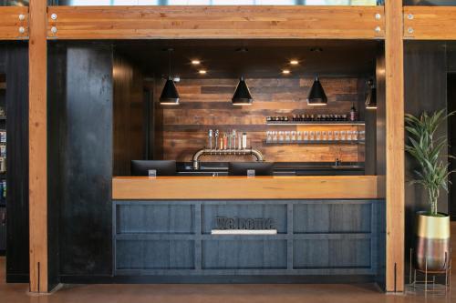 a kitchen with wooden cabinets and a wooden counter top at Waypoint Hotel in Bend