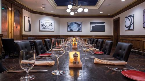 a conference room with a long table with wine glasses at Garden City Hotel in Garden City