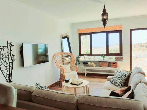 a living room with a couch and a table at Los Ancones Apartment in Costa Teguise