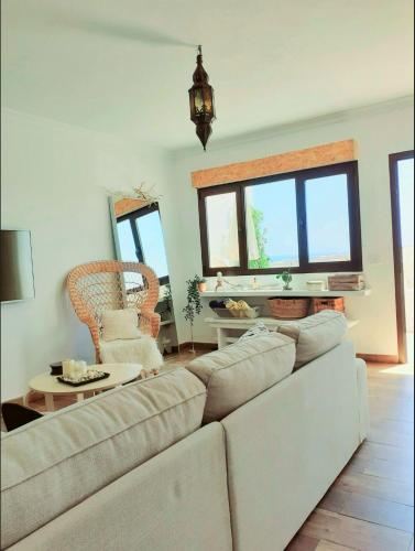 a living room with a couch and a table at Los Ancones Apartment in Costa Teguise