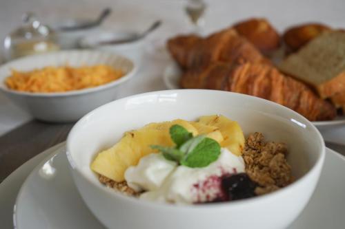 a white bowl of food on a plate with pastries at Julsie's Home in Reebok