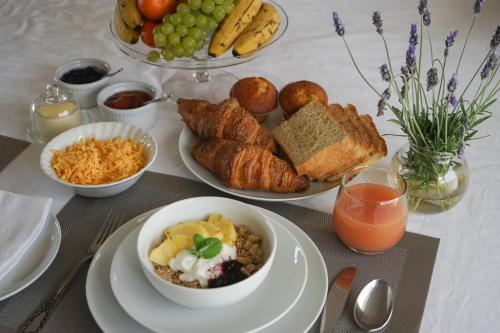 a table with plates of food and bowls of bread and fruit at Julsie's Home in Reebok