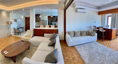a living room with two couches and a table at Modern 2 bed room large apartment in Nicosia