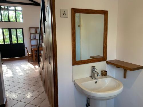 a bathroom with a sink and a mirror on the wall at Lilac Hideaway in Karatu