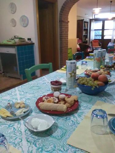 a table with a blue table cloth with food on it at B&B Valverde in Dorgali