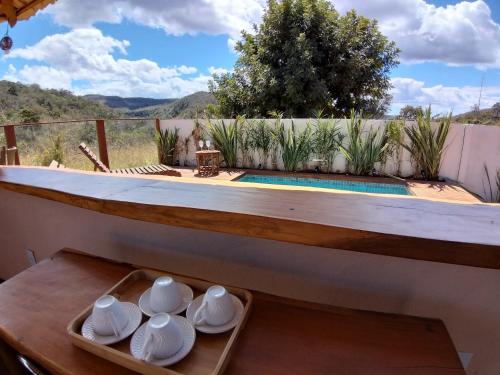 a room with a table with bowls and plates on it at Vila Gaia Guest House in Alto Paraíso de Goiás
