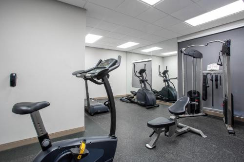 a gym with several exercise bikes and tread machines at Hawthorn Extended Stay by Wyndham Loveland in Johnstown