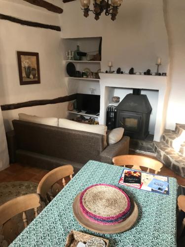 a living room with a table and a fireplace at El Portal de Moratalla in Moratalla
