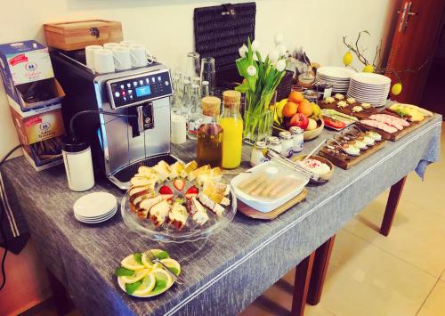 a table with a buffet of food on it at Willa Potok in Krynica Zdrój