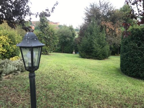 a black lamp post in a field of grass at Villa Belforte in Tonco