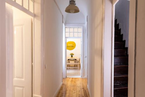a hallway with white walls and a staircase in a room at Faro Guest House in Faro