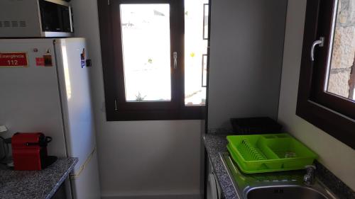a kitchen with a green tray next to a sink at Louro's Villa - 12130AL in Cantanhede