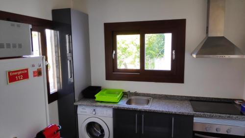 a kitchen with a sink and a washing machine at Louro's Villa - 12130AL in Cantanhede
