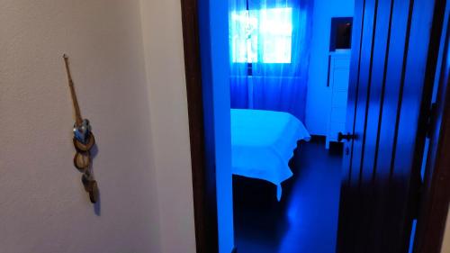 a room with a blue room with a table and a door at Louro's Villa - 12130AL in Cantanhede
