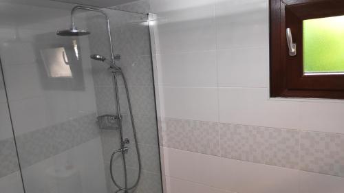 a bathroom with a shower with a glass door at Louro's Villa - 12130AL in Cantanhede