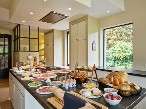 a kitchen with a buffet of food on a counter at Boutique Hotel Ter Wallen in Izegem