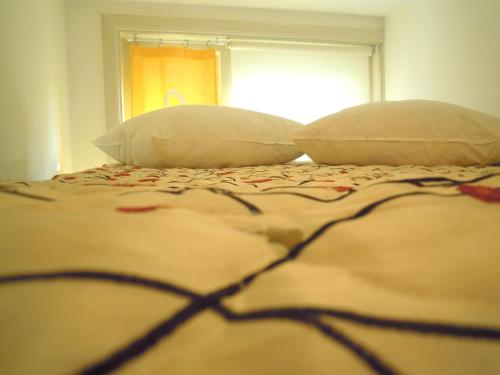a bed with two pillows and a blanket on it at MissOrtelia B&B in Amsterdam