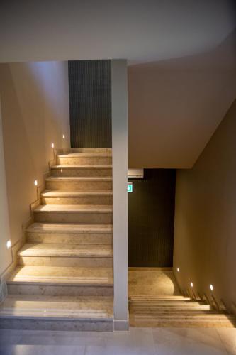 a set of stairs in a building with lights at Lignum Hotel in Miskolctapolca