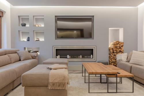 a living room with a couch and a fireplace at Casa Abego in Cangas de Onís