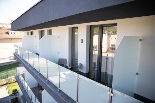 an external view of a house with a balcony at Lignum Hotel in Miskolctapolca