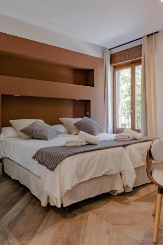 a bedroom with a large bed and a window at Casa Abego in Cangas de Onís
