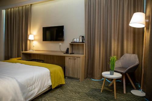 Postel nebo postele na pokoji v ubytování Lignum Hotel