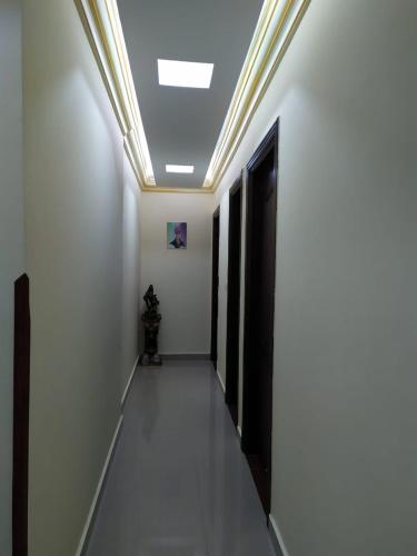 a hallway with white walls and a ceiling at Stanley Bridge Apartment in Alexandria