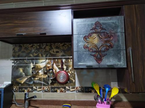 a kitchen with a sink and a painting on the wall at Stanley Bridge Apartment in Alexandria