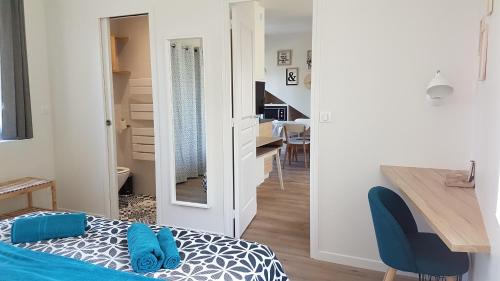 a room with a bed and a desk and a table at CDG Aparts in Le Mesnil-Amelot