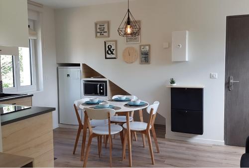 a kitchen and dining room with a table and chairs at CDG Aparts in Le Mesnil-Amelot