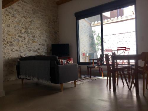 a living room with a couch and a table at LOFT COCON EN PLEIN CENTRE DE SETE in Sète