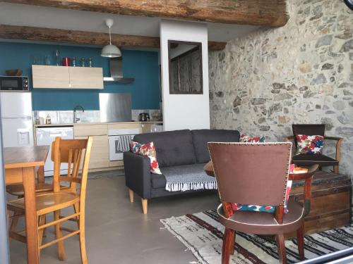 a living room with a couch and a table and chairs at LOFT COCON EN PLEIN CENTRE DE SETE in Sète