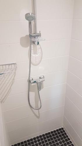a shower in a white bathroom with a sink at CDG Aparts in Le Mesnil-Amelot