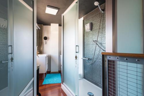 a bathroom with a shower and a glass door at Loft La Fuente in Telde