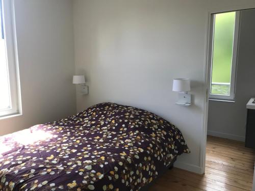 sypialnia z łóżkiem z narzutą kwiatową w obiekcie bord de seine w mieście Bar-sur-Seine