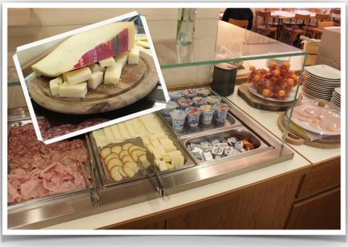 a display case with cheese and other food items at Hotel Miramonti in Schio