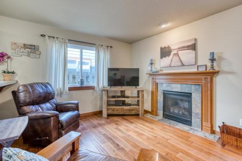 a living room with a chair and a fireplace at Seaside Upscale Townhome in Seaside