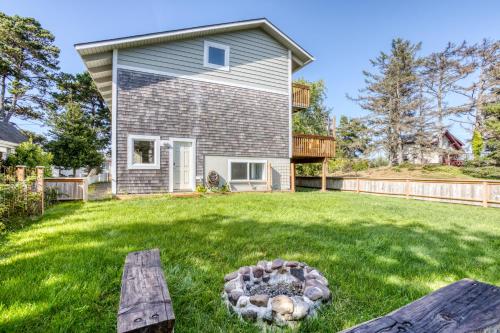 a home with a fire pit in the yard at Seaside Serenity Near the Sea in Seaside