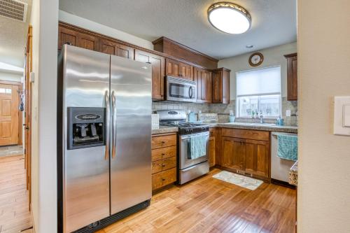 a kitchen with a stainless steel refrigerator and wooden cabinets at Seaside Upscale Townhome in Seaside
