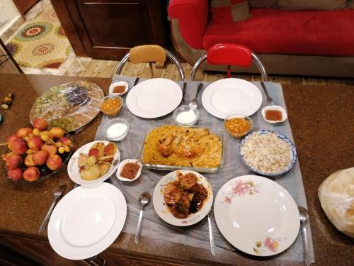 a table topped with plates of food on a table at Mhna guest house in Ajloun