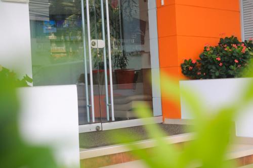 a glass door of a store with potted plants at Hotel Cabreromar in Cartagena de Indias