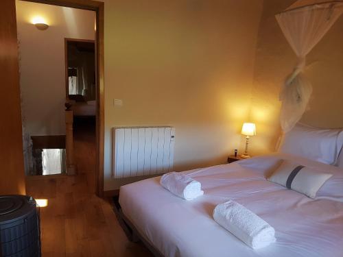 a bedroom with a large white bed with two pillows at Abrigo Montesinho in Montezinho