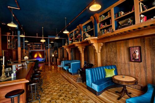 a bar with blue chairs and a counter in a room at The Inn at 2nd & C in Eureka