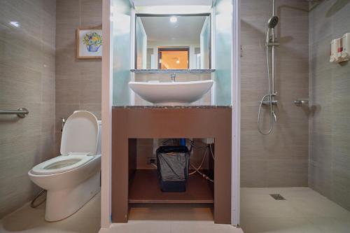 a bathroom with a sink and a toilet in it at Achievers Airport Hotel in Manila