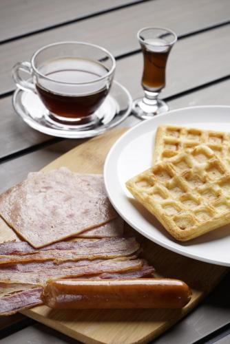 a plate of toast and waffles and a cup of coffee at Achievers Airport Hotel in Manila