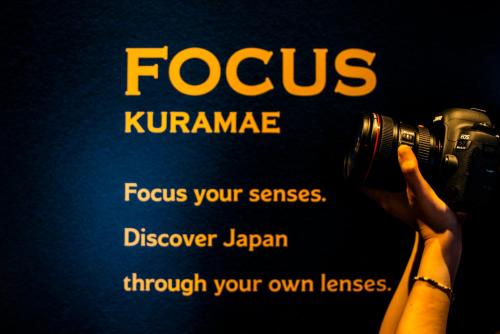 a person taking a picture with a camera at Focus Kuramae in Tokyo
