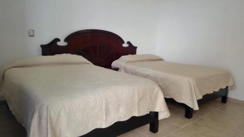 two beds sitting next to each other in a room at Casa de Cactus in Bernal