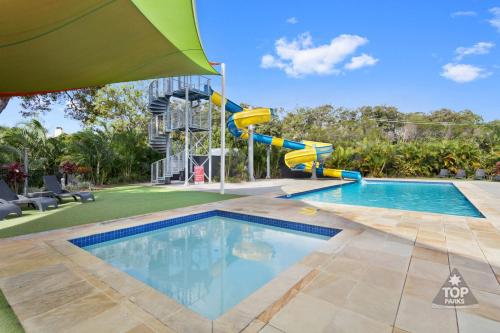 a swimming pool with a slide and a water park at Nobby Beach Holiday Village in Gold Coast